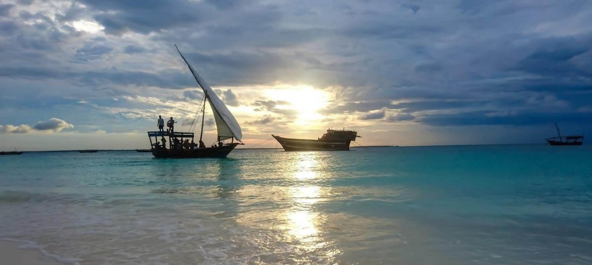 Dhows on turquoise water off Zanzibar at sunset
